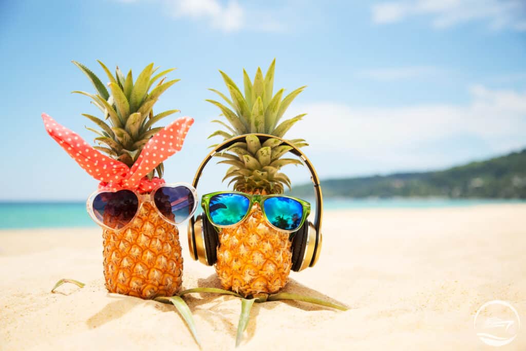 Two pineapples enjoying some beach time